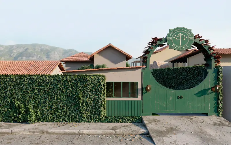Portão verde em arco com o brasão do Tortoreto Boutique Hotel